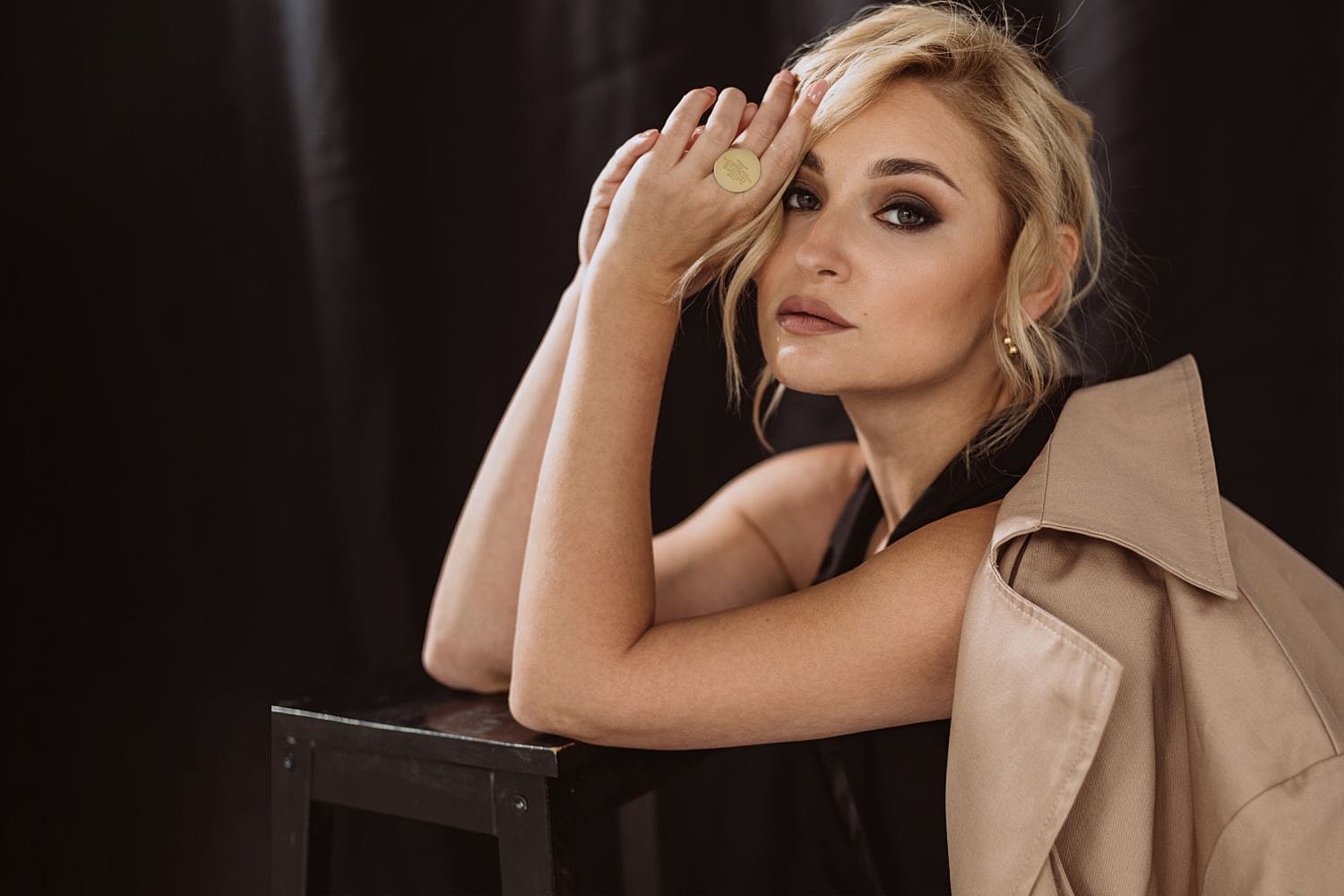 Woman with styled blonde hair posing elegantly.