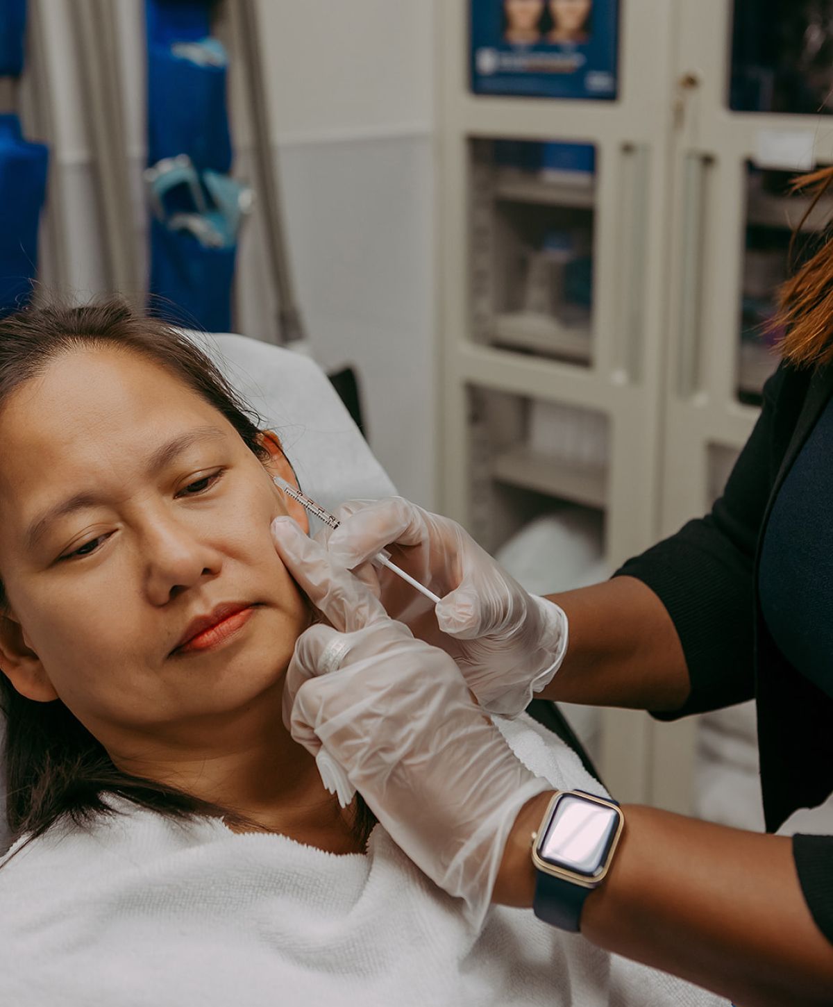 Patient receiving aesthetic treatment in clinic setting.