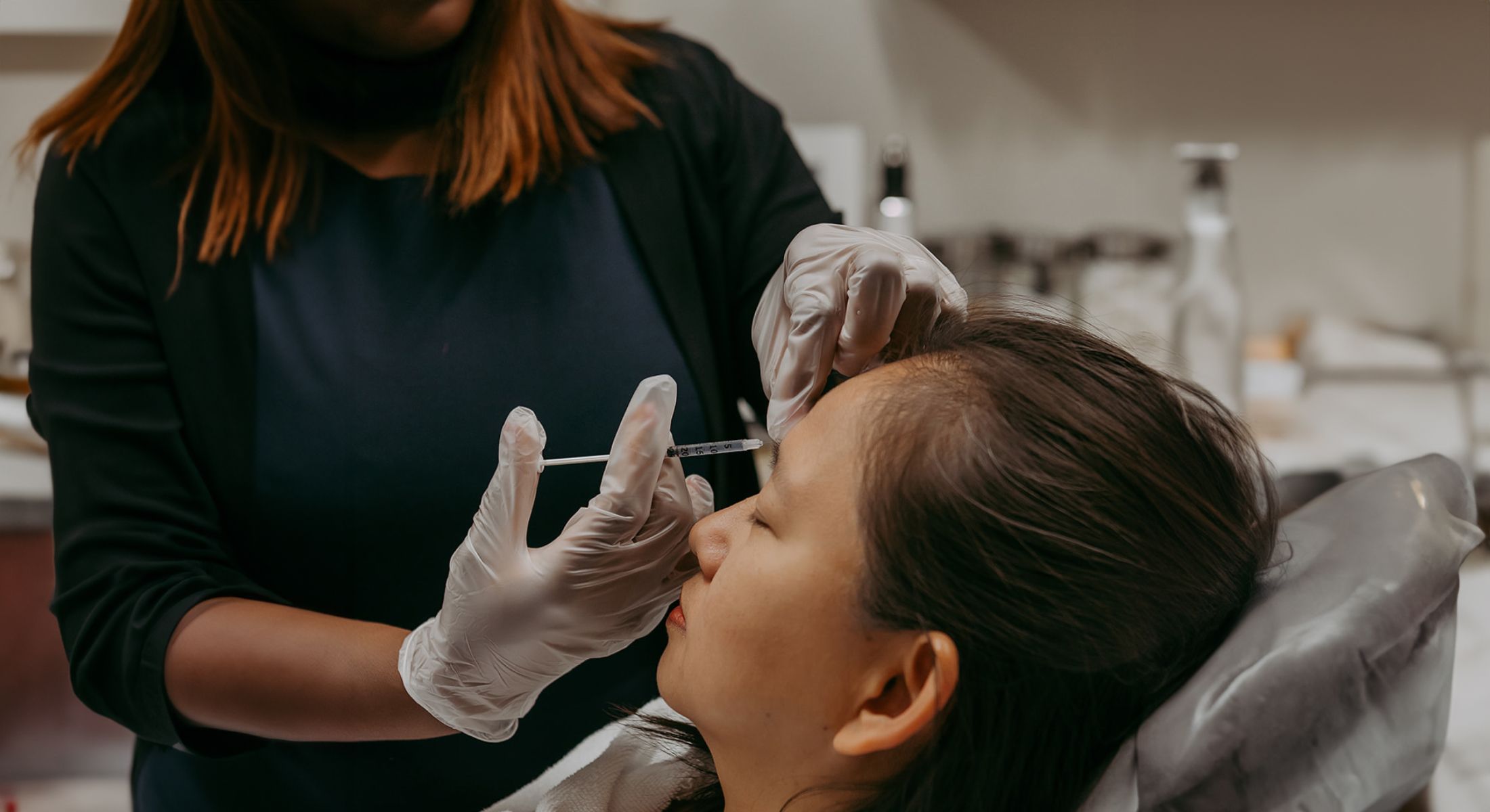 Administering cosmetic injection in a beauty clinic.